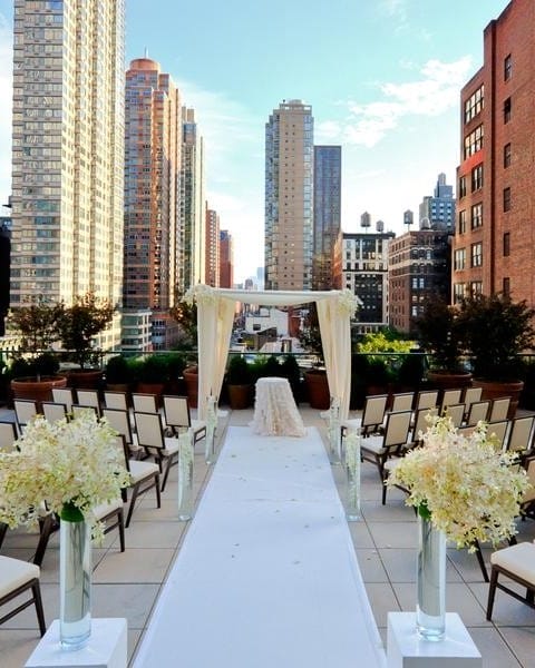 A decorated rooftop wedding venue overlooking New York City