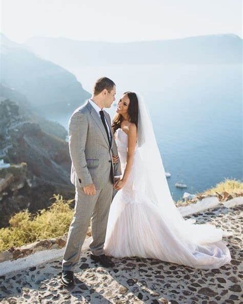 A photo of a couple getting their photo taken at their destination wedding